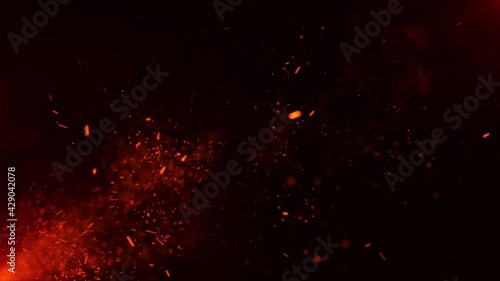 Beautiful burning hot sparks rising from large fire in night sky. Abstract fire glowing particles on black background