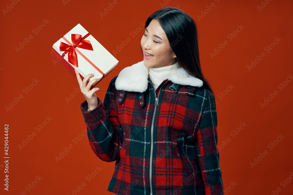 woman with gift box and warm jacket on red background cropped view woman with gift box and warm jacket on red background cropped view