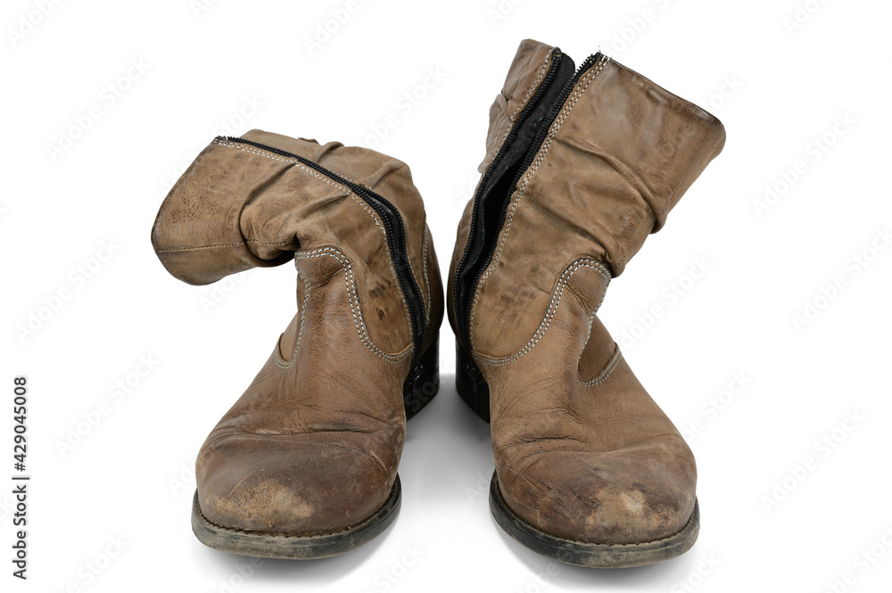 Women's worn ankle boots in light brown suede. Boots with a zipperd on white background.