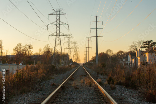 Vanishing point train tracks and power lines heading to the horizon.