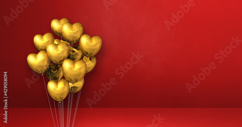 Gold heart shape balloons bunch on a red wall background. Horizontal banner.