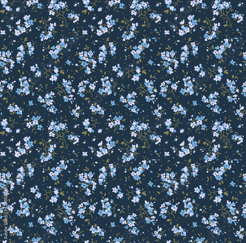 Cute floral pattern. Seamless vector pattern. Elegant template for fashion prints. Small light blue flowers. Dark blue background. Summer and spring motifs. Stock vector.
