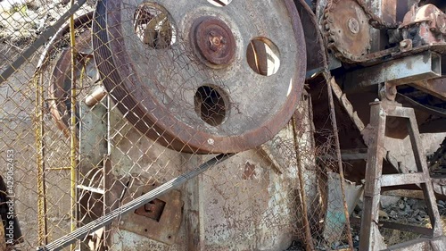 close up of old wheel of a stonebreaker machine photo