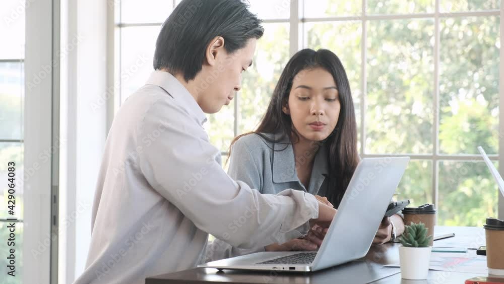 Two young asian businessman and woman talking about business ideas for future trend. Two young asian businessman and woman talking about business ideas for future trend.