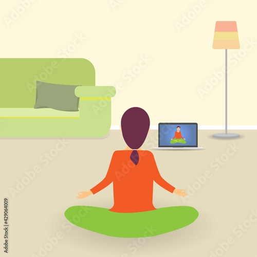 Young woman indoors sitting on the floor and meditating in lotus position, looking at tv