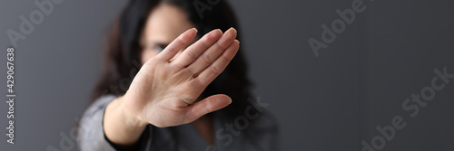 Woman shows negative gesture with her hand. photo