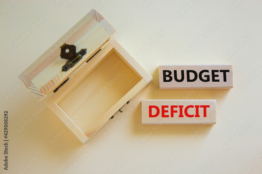Budget deficit symbol. Concept words 'budget deficit' on blocks on a beautiful white background, small empthy chest. Business and budget deficit concept, copy space. Budget deficit symbol. Concept words 'budget deficit' on blocks on a beautiful white background, small empthy chest. Business and budget deficit concept, copy space.