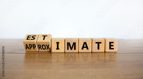 Estimate or approximate symbol. Turned wooden cubes and changed the word 'approximate' to 'estimate'. Beautiful wooden and white background, copy space. Business, estimate or approximate concept. photo