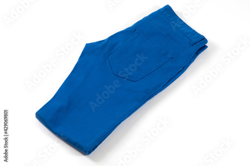 Blue jeans isolated on white background. Folded casual style trousers or pants. 