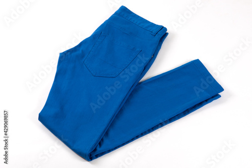 Blue jeans isolated on white background. Folded casual style trousers or pants. 