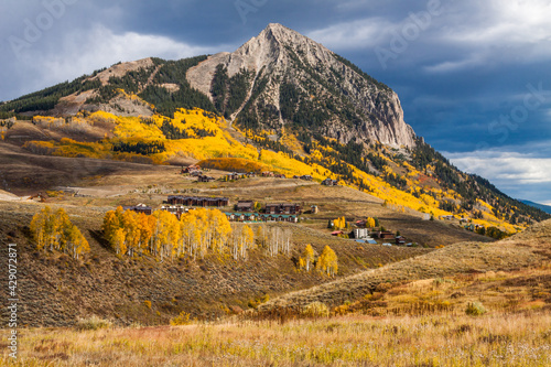 The landscape of the town of Mt. Crested Butte Colorado in Autumn under storm clouds under Mount Crested Butte photo