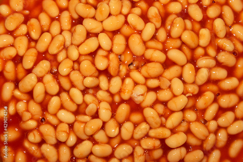 close-up of baked beans with tomato sause. top view