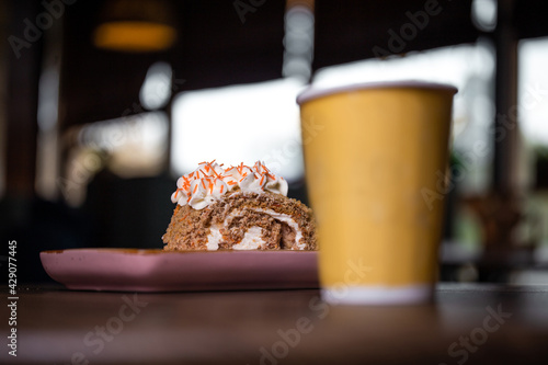 dessert and a cup of coffee on a wooden table in a cafe