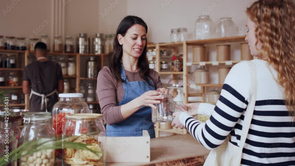 Young woman buying fresh pasta in zero waste shop. Young woman buying fresh pasta in zero waste shop.