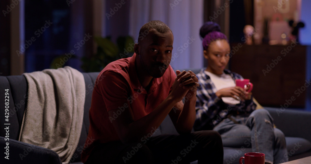 African american negative offended couple of sad boyfriend and girlfriend sitting separately on sofa thinking about divorce. Relationship problems.