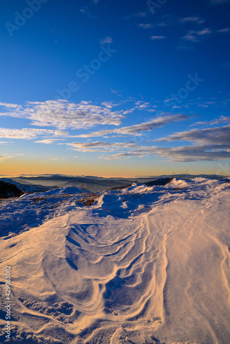 sunrise in a snow covered mountains