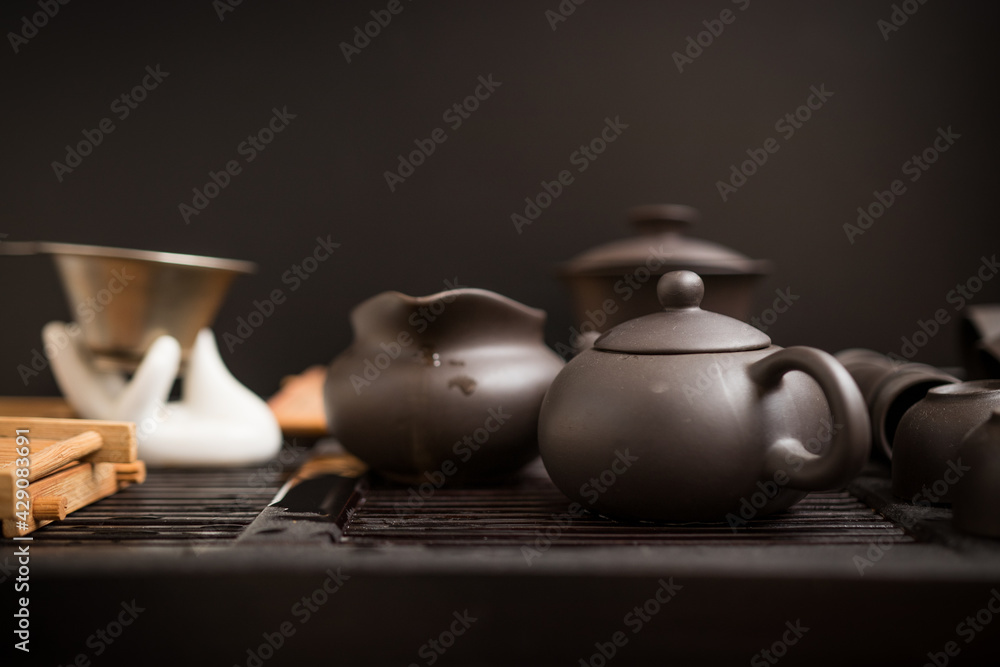 Chinese tea set for brewing tea on a black background. Asia, dishes, clay, object, teapot, ceremony, ritual, meditation