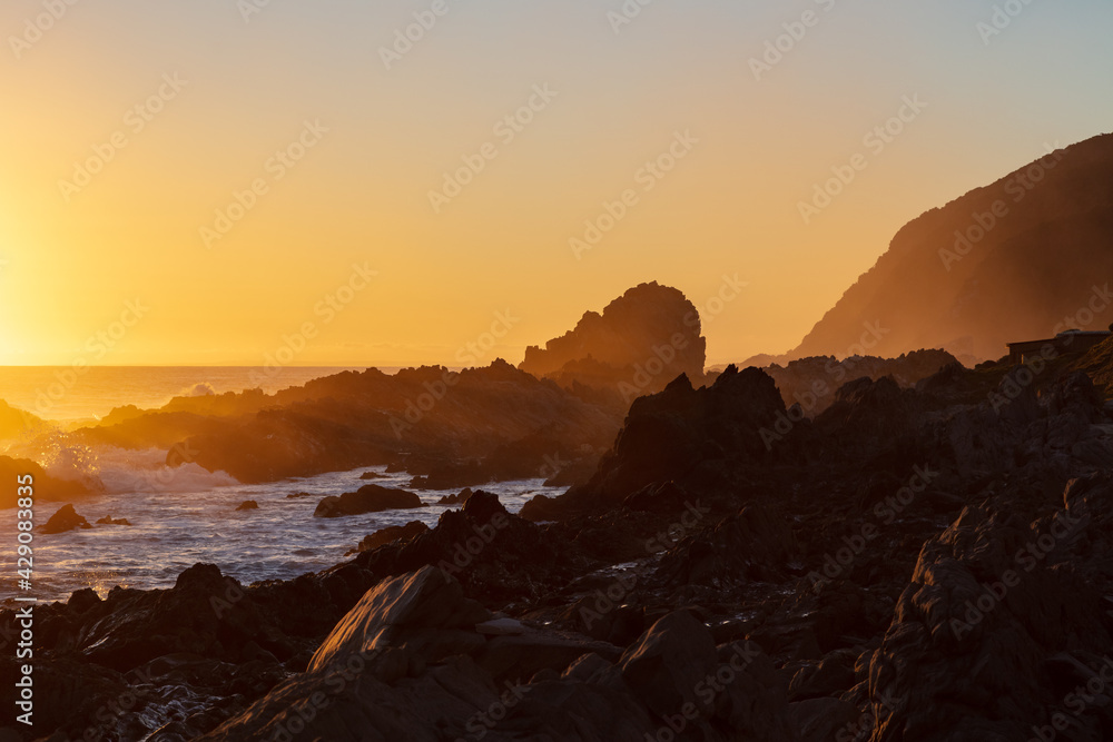 Golden glow of sunrise at a rocky beach
Golden glow of sunrise at a rocky beach