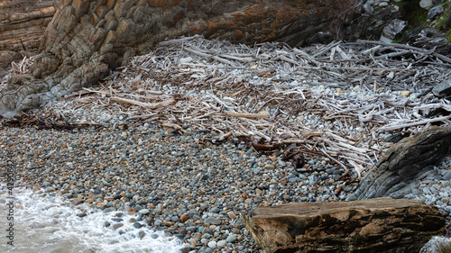 Smooth stones and driftwood on the beach
