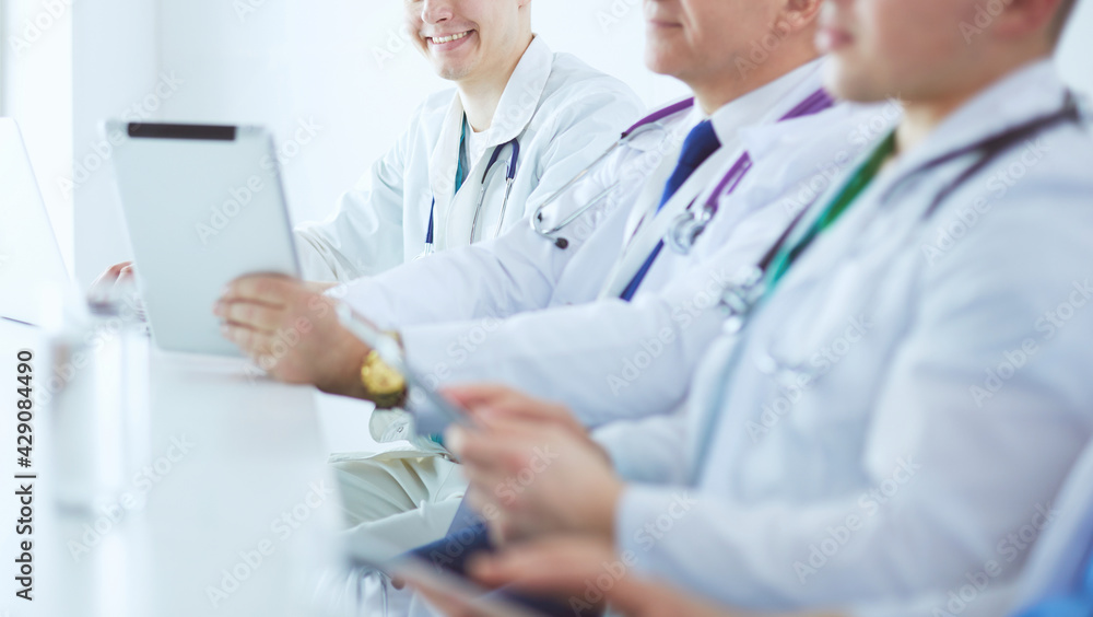 Medical team sitting and discussing at table Medical team sitting and discussing at table