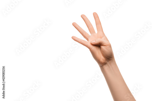 A woman's hand shows four fingers on a white background