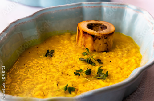 Obraz na plátně Yellow risotto alla milanese with saffron and bone marrow on a plate
