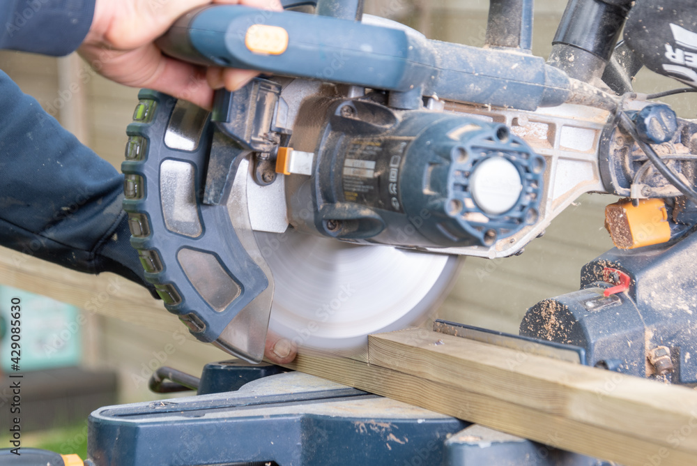 Fototapeta premium Carpenter using circular saw in DIY project.