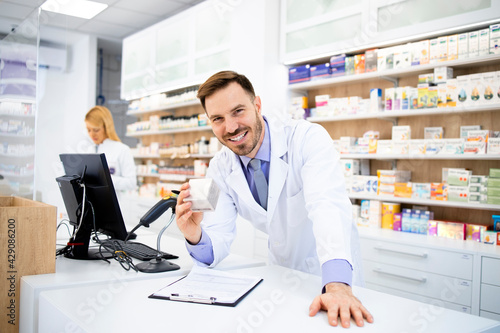 Pharmacist selling medicines in drug store.