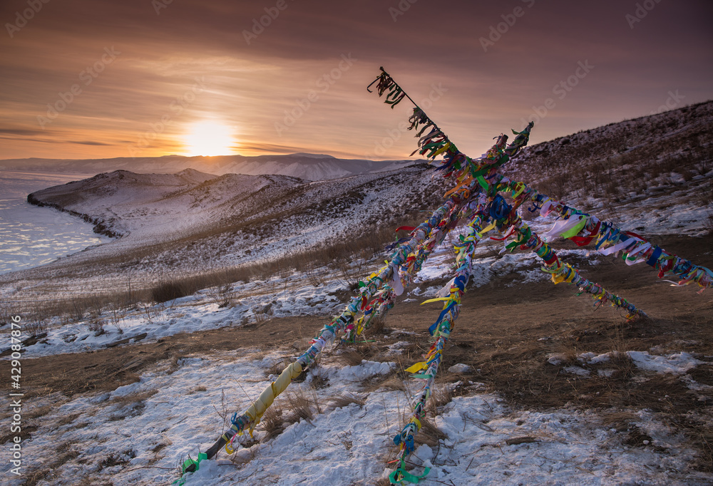 Tribal Ritual Binding Posts Colored ritual ribbons tied on the tree and wooden poles as a buddhist ...