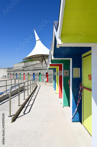 A row of colorful beach huts at Barry Island, Wales, UK