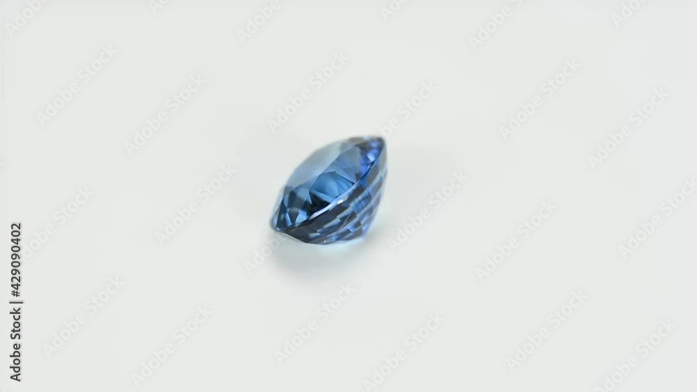 Cornflower blue natural Sry-Lanka precious sapphire Ceylon. Oval faceted, gentle heat, eye clean, VVS, loose cornflower blue gem setting. Gray patterned background. Expensive sample gemstone. Cornflower blue natural Sry-Lanka precious sapphire Ceylon. Oval faceted, gentle heat, eye clean, VVS, loose cornflower blue gem setting. Gray patterned background. Expensive sample gemstone.