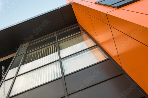 Geometric colored building facade elements with planes, lines and corners with light flare and reflections for an abstract background and texture of white, blue, gray colors. Place for text