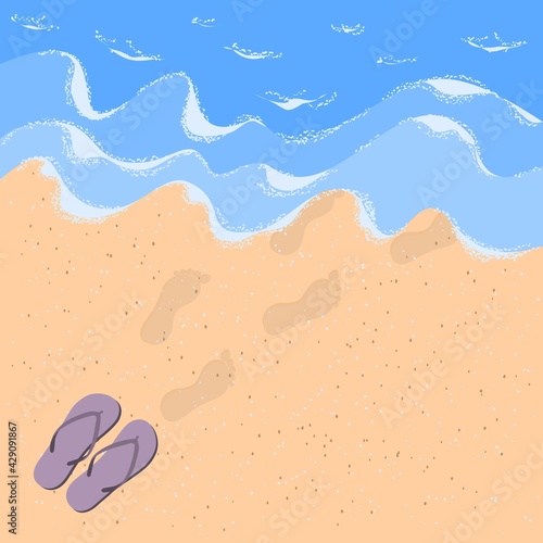 Flip flops and steps on the sand by the sea. Sandy beach with waves, sea foam and flip flops with human footprints in the sand.Summer vacation concept on the sandy beach of the ocean.