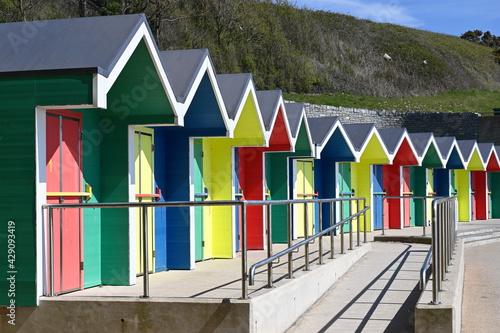 A row of colorful beach huts at Barry Island, Wales, UK