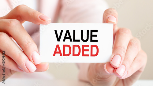 VALUE ADDED written on a card in woman hands