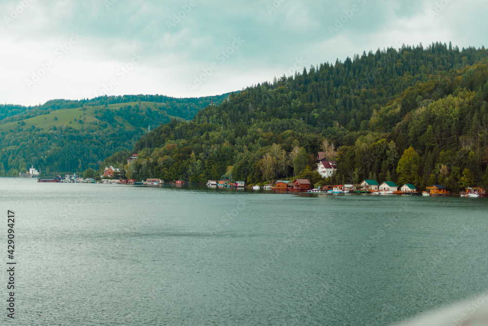 Famous lake side view of Izvorul Muntelui, Romania. Beautiful and colorful holiday homes by the lake. Great location for tourism.