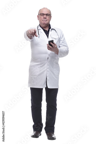 in full growth. Mature doctor reading a message on his smartphone