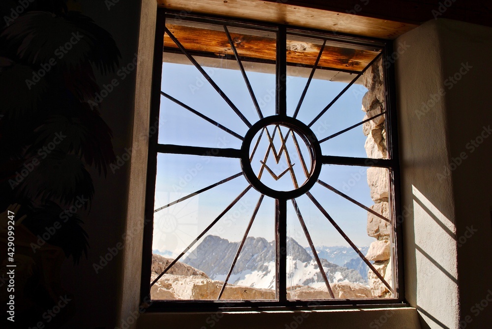 Zugspitze, Germany: A window looks out from the Maria Heimsuchung Chapel. It's  surrounded by Austrian and German alps. The chapel was consecrated in 1981 by the emeritus Pope Benedict XVI.