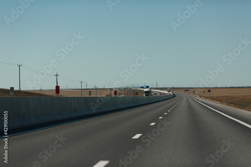 An empty highway stretching into the distance. Road and markings.