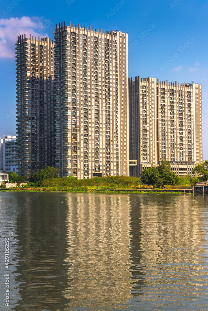 Modern Apartment Buildings on a Sunny Day with a Blue Sky on Chao Phraya River Embankment in Bangkok, Thailand