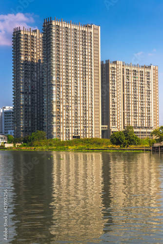 Modern Apartment Buildings on a Sunny Day with a Blue Sky on Chao Phraya River Embankment in Bangkok  Thailand