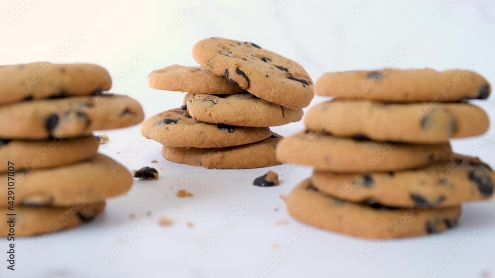 Stacks of tasty chocolate chip cookie. Presentation of dessert in cafe or restaurant menu. Delicious snack for tea or coffee. Camera movement changing focus from one stack to another. Stacks of tasty chocolate chip cookie. Presentation of dessert in cafe or restaurant menu. Delicious snack for tea or coffee. Camera movement changing focus from one stack to another.