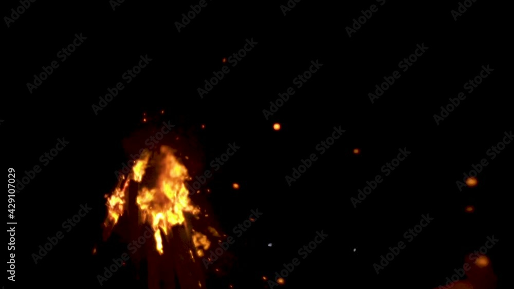 Log fire burns in wind at night, throwing out flames and sparks into blackness slow mo. idea of sacred fire, purification with flames concept Log fire burns in wind at night, throwing out flames and sparks into blackness slow mo. idea of sacred fire, purification with flames concept