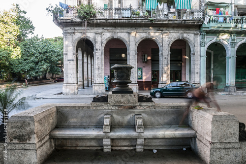 Ghosted image of a boy climbing on a park bench on the Prado with Old Havana, Cuba.