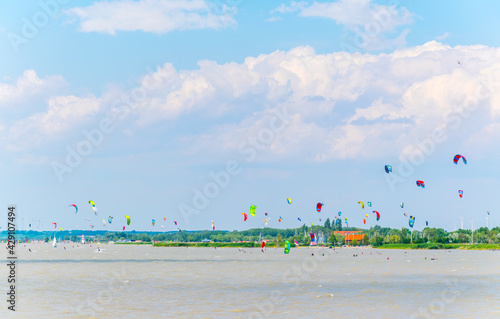 Young people are kite surfing on the neusiedlersee lake in Austria near Podersdorf am See town. photo