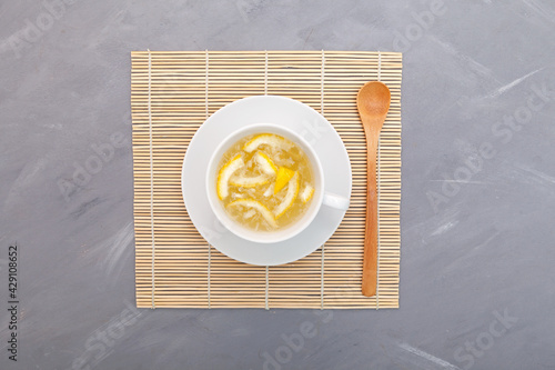 Yujacha (yuja tea or yuzu tea) - Traditional Korean citron tea. Top view, grey background, copy space photo