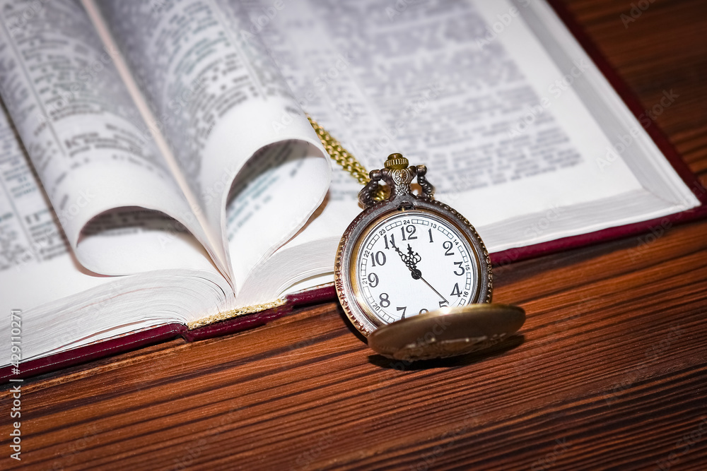 a pocket watch with book background a pocket watch with book background