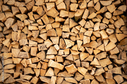 wall firewood , Background of dry chopped firewood logs in a pile.