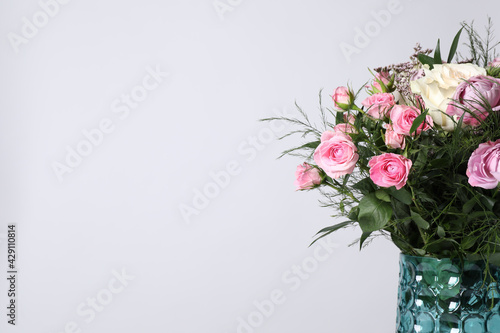 Beautiful bouquet with roses on white background  closeup. Space for text