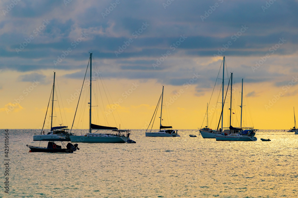 Yacht boat sailing boats or Travel boats in Beautiful open sea at sunset golden sky Amazing for summer holiday background and Travel destination or Website